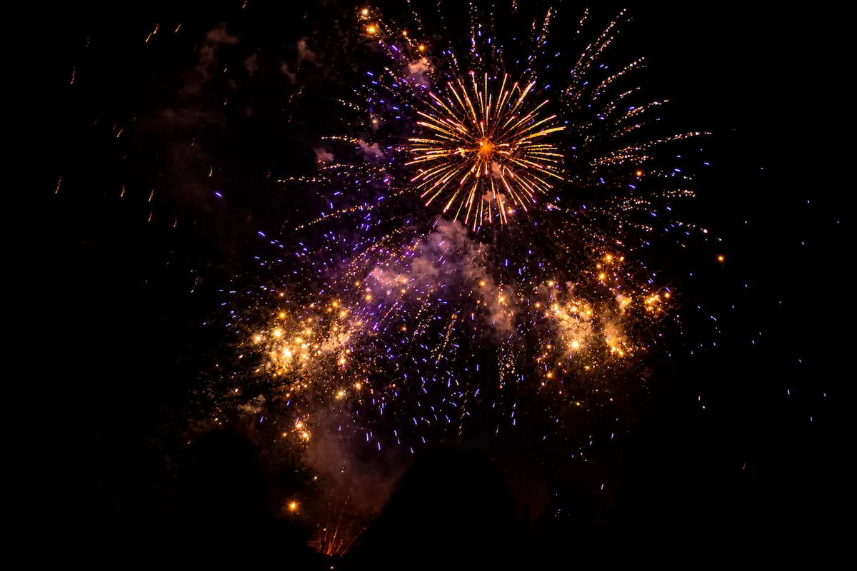 Bright nighttime fireworks representing how loud explosions can trigger distress for people experiencing PTSD fireworks.
